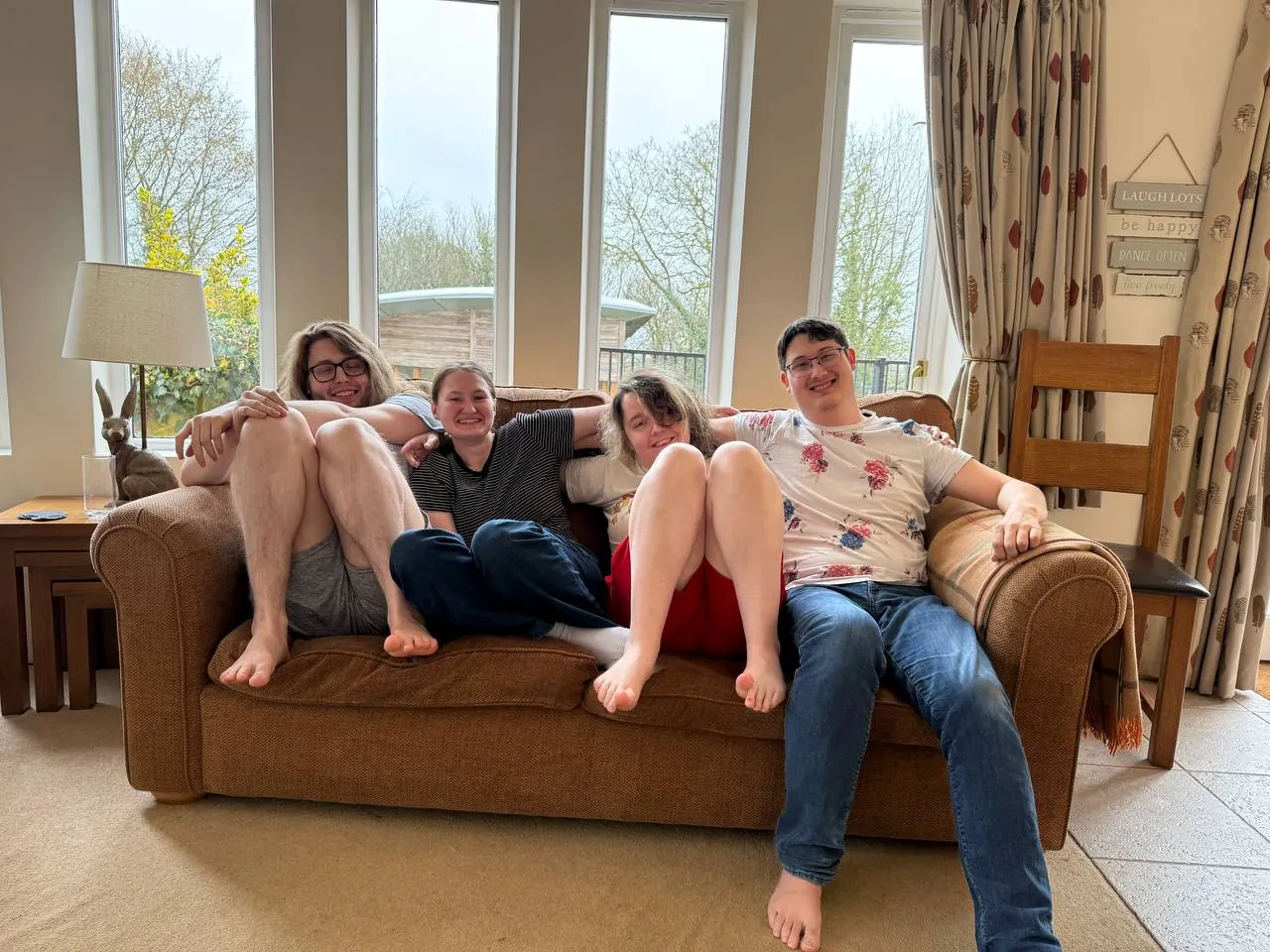 Four WanderRock travelers relaxing together on the couch