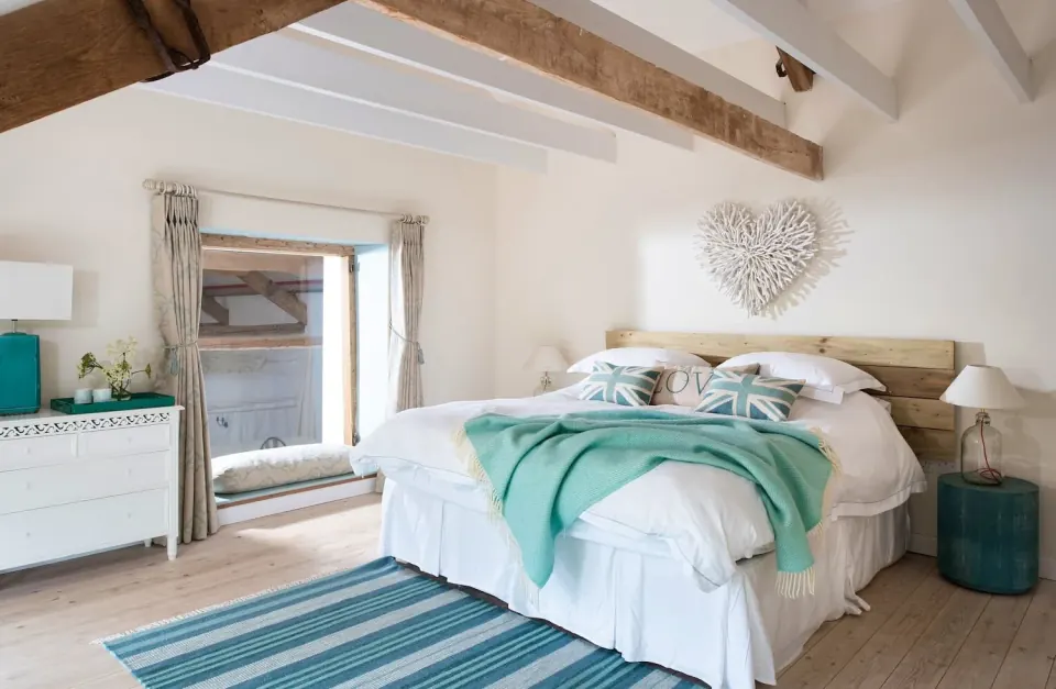 A bedroom with exposed beams at the country house in Somerset