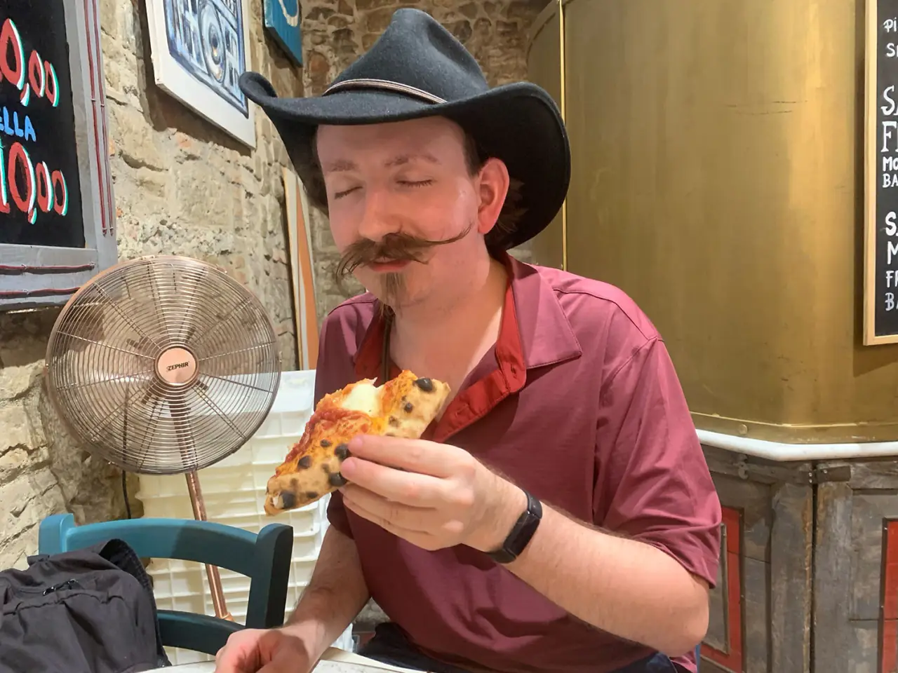 A traveler eating pizza in Italy