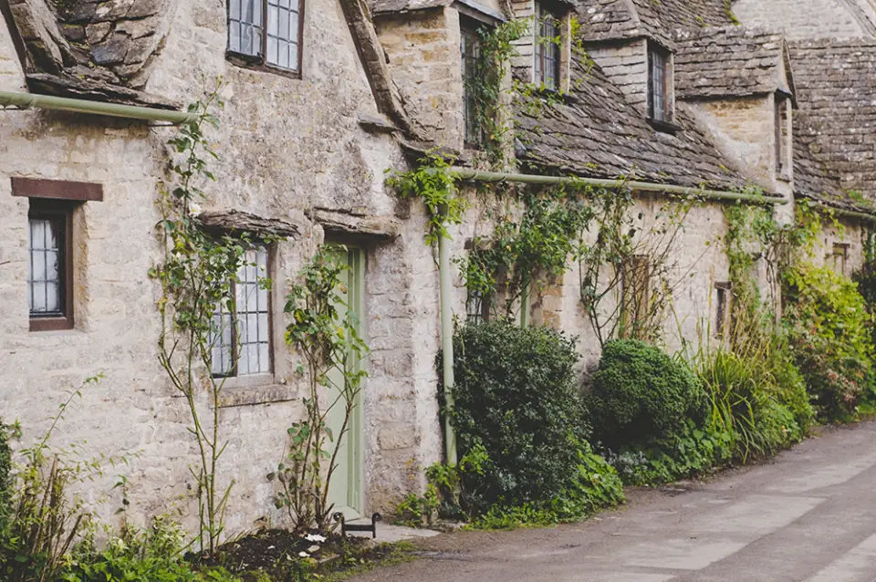 Cobbled lane lined with stone cottages in the English countryside