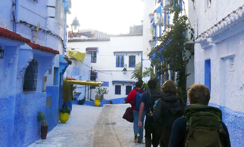 WanderRock travelers walking through Chefchaouen, Morocco