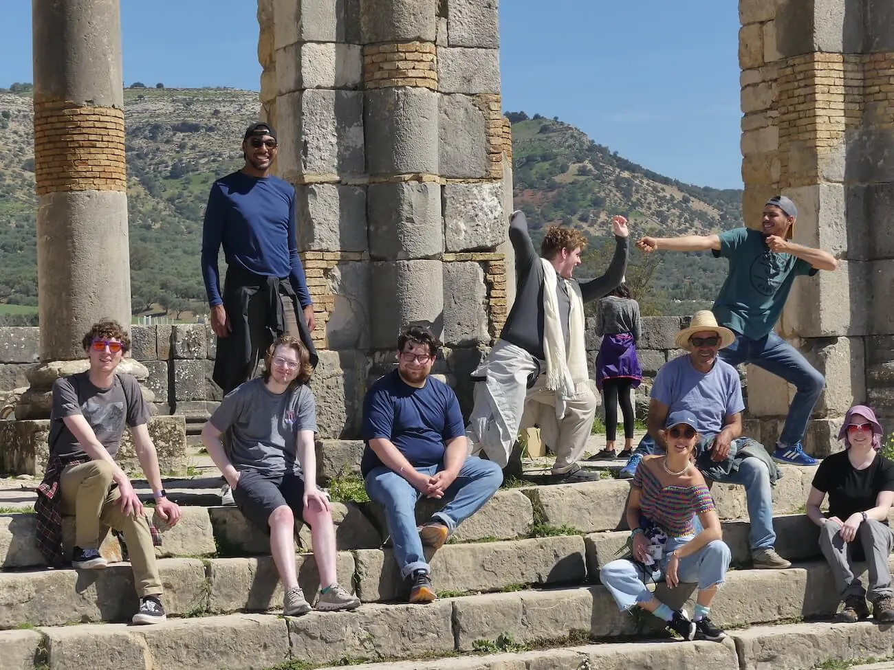 WanderRock travelers and guides together at the Roman ruins of Volubilis in Morocco